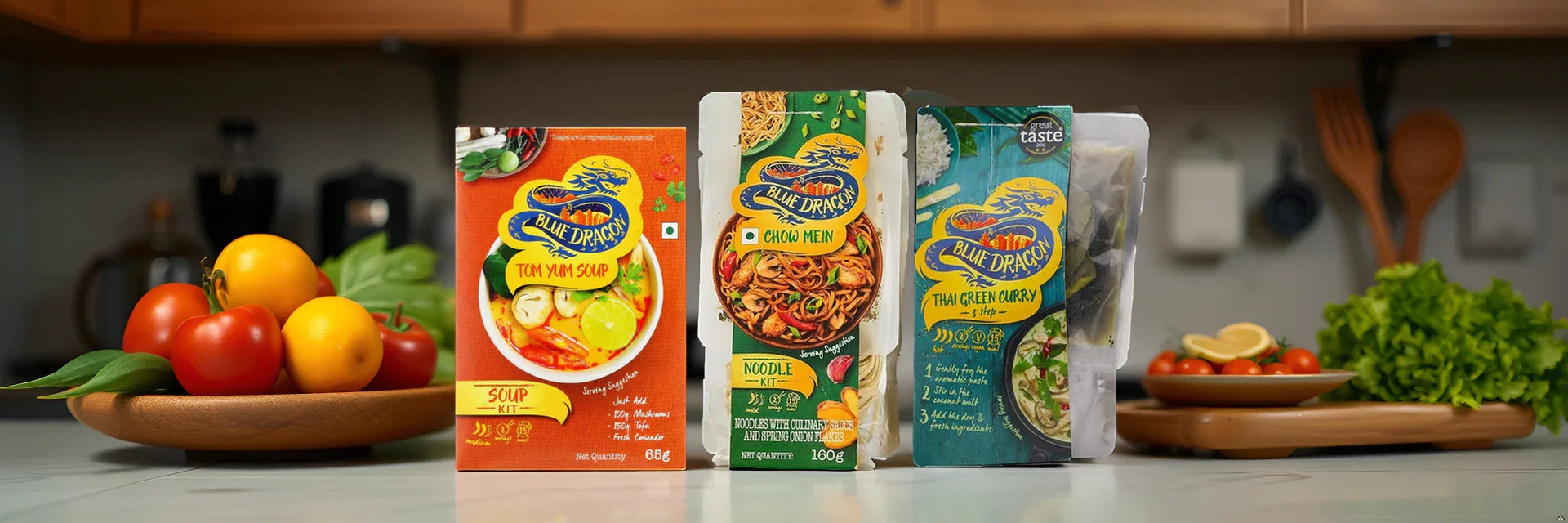 Blue Dragon Tom Yum Soup, Chow Mein & Thai Green Curry kits with fresh veggies in kitchen
