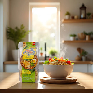 Steaming bowl of ramen with vegetables beside Blue Dragon ramen noodle kit in bright kitchen