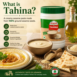Al Wadi Tahina container with sesame seeds, hummus, and pita on a wooden table.