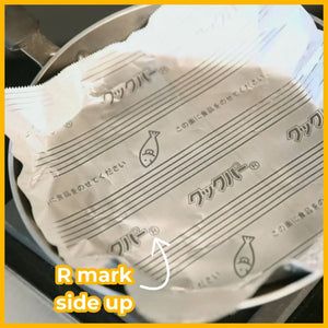 Non-stick frying pan foil sheet with fish icon placed in a metal pan, labeled 'R mark side up'.
