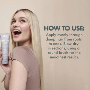 Blonde woman holding Umberto Giannini Blow Out Frizz Styling Cream with usage instructions on beige background