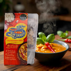 Blue Dragon Thai Massaman Curry 3-step kit with steaming curry bowl garnished with chili and basil