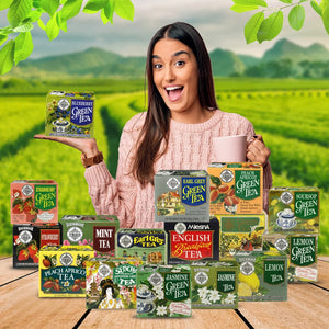 Woman holding a blueberry green tea box, surrounded by assorted tea boxes in a tea garden.