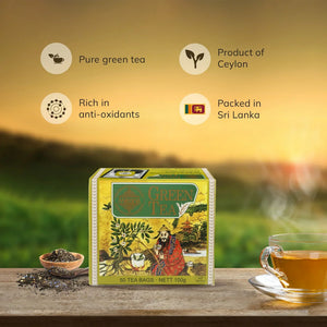 Box of Ceylon green tea bags, loose tea, and glass cup on wooden table with nature background