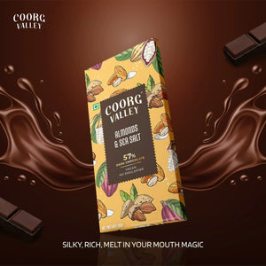Coorg Valley Almonds & Sea Salt 57% dark chocolate bar with illustrated almond pods and chocolate splash