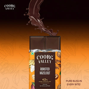 Coorg Valley Roasted Hazelnut dark chocolate bar with 42% cocoa and chocolate splash background
