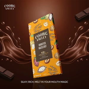 Coorg Valley Roasted Hazelnut 42% dark chocolate bar with vegan no emulsifier label on brown background