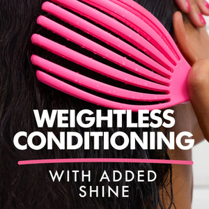Close-up of wet black hair being detangled with a pink wide-tooth comb promoting weightless conditioning and added shine