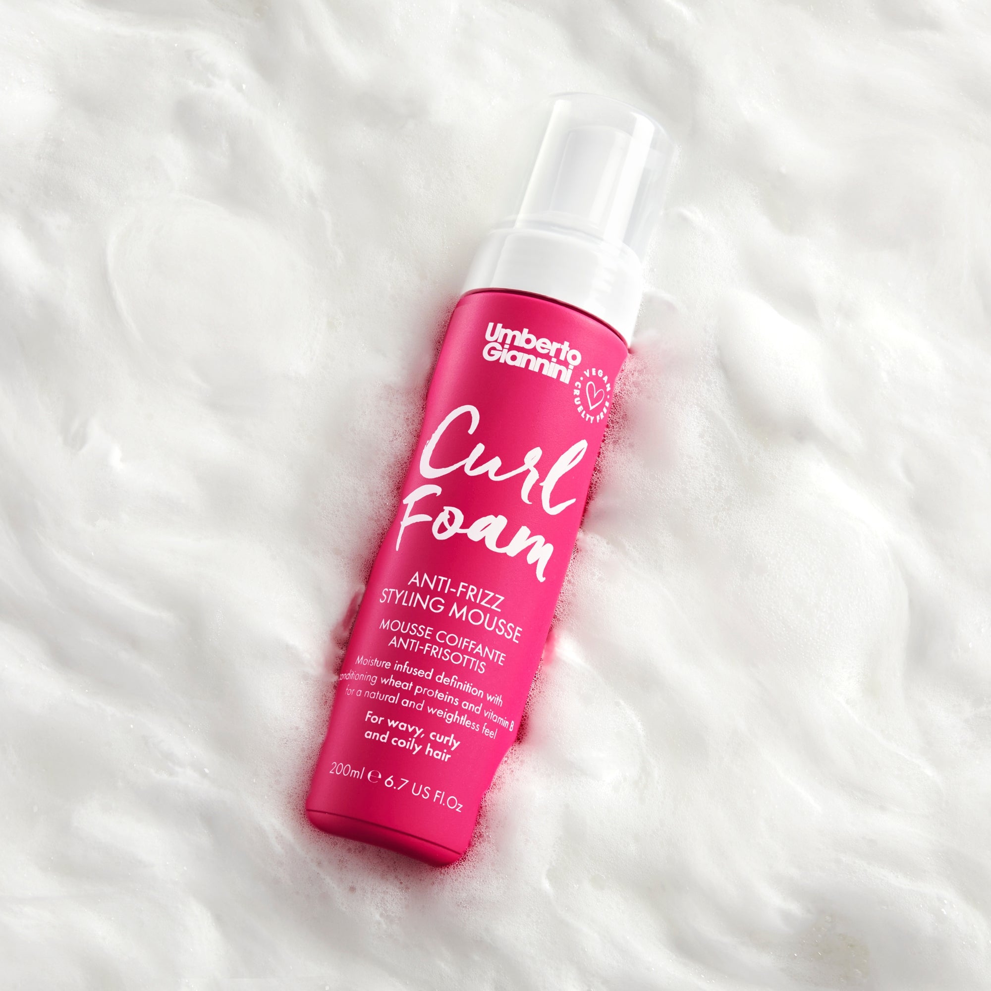 Umberto Giannini Curl Foam anti-frizz styling mousse bottle on white foam background