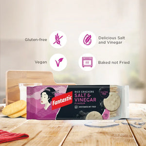 Salt and vinegar rice crackers, gluten-free, vegan, baked not fried, on wooden table