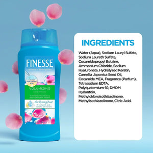 Finesse Volumizing Shampoo bottle with ingredient list, pink petals, on blue background