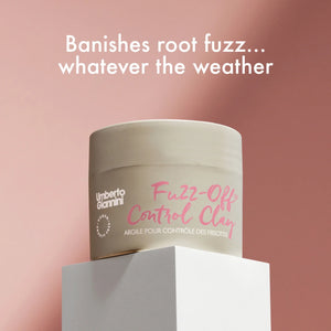 Umberto Giannini Fuzz-Off Control Clay jar on white pedestal with pink backdrop, anti-frizz hair styling product