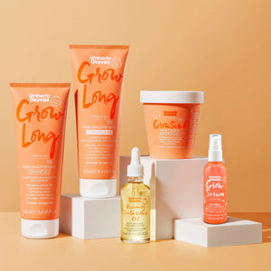 Umberto Giannini Grow Long hair care set with hair lengthening shampoo, conditioner, scalp scrub, rosemary scalp oil, and grow serum on beige background