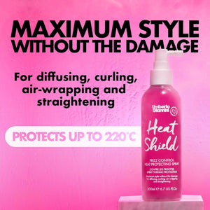 Umberto Giannini Heat Shield frizz control heat protecting spray bottle on pink background with styling claims