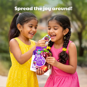 Two smiling girls enjoying grape flavoured jelly outdoors, holding Grab n Go jelly pack.