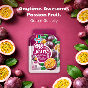 Passion fruit jelly pouch on pink background with fresh passion fruits and green leaves
