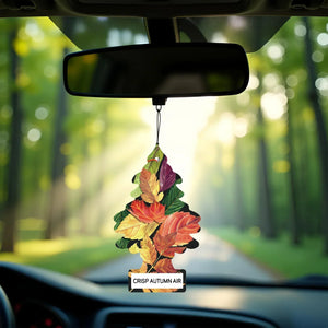Little Trees Crisp Autumn Air car freshener with colorful leaves hanging from a rearview mirror