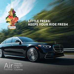 Little Trees Crisp Autumn Air car air freshener with autumn leaves, black luxury sedan driving outdoors.