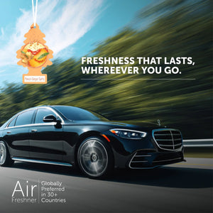 Peach Ginger Spritz Little Trees car air freshener hanging above a luxury car on a road, promoting freshness.