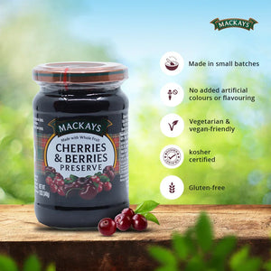 Mackays Cherries & Berries Preserve jar on wooden surface with fresh cherries and bullet points of product features