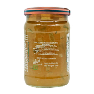 Clear glass jar of lime and lemon marmalade with chunks, metal lid, ingredient label visible