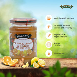 Jar of Mackays Orange Lemon Ginger Marmalade with fresh citrus fruits and ginger on wooden surface