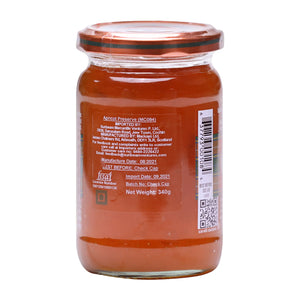 Jar of Mackays Scottish apricot preserve with clear label and orange lid on white background
