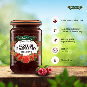 Jar of Mackays Scottish Raspberry Preserve on wooden table with fresh raspberries, vegan and gluten-free