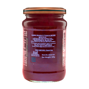 Back view of a glass jar labeled Scottish strawberry preserve, showing ingredients and product details.