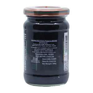 Sealed jar of seedless blackberry preserve with nutrition and import details on the label