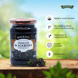 Jar of Mackays Seedless Blackberry Preserve with fresh blackberries on wooden surface and product benefits