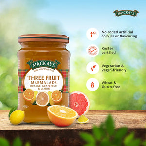 Jar of Mackays Three Fruit Marmalade with orange, grapefruit, and lemon on wood surface, vegan and gluten-free