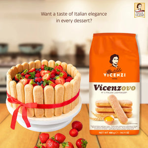 Italian ladyfinger biscuits package next to a charlotte cake with strawberries and ribbon
