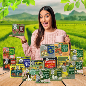 Woman holding mint tea box with assorted tea varieties on table, tea garden background