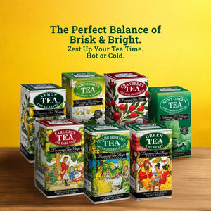 Assorted luxury tea boxes including lemon, jasmine green, cranberry, and mint green tea on a wooden surface with a yellow background.