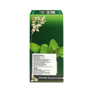 Green tea box with mint leaves and gold floral design on green background
