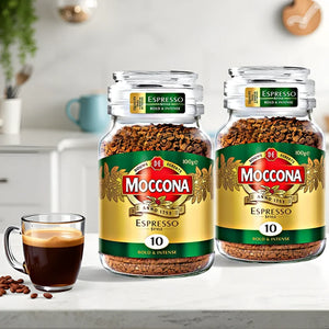 Two jars of Moccona Espresso Style instant coffee with bold & intense flavor, 100g each, beside a cup of espresso on a kitchen counter