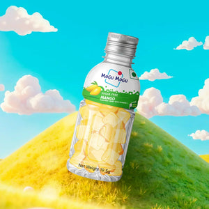 Mogu Mogu sugar free mango candy bottle with yellow candy pieces on a grassy hill background