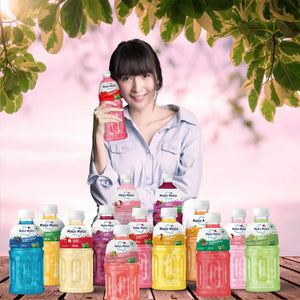 Woman holding a Mogu Mogu drink with assorted fruit juice bottles displayed outdoors.