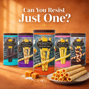 Salted caramel wafer sticks in a tin with plate of rolled wafers and caramel pieces in front