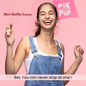 Smiling woman holding vanilla mini waffle cone treat against pink background, text reads 'Mini Waffle Cones'.
