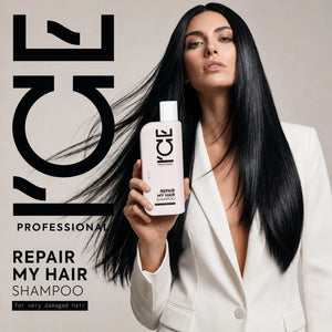 A woman in a white blazer holding a bottle of ICE Professional Repair My Hair Shampoo.