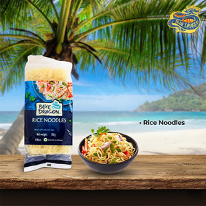 Blue Dragon rice noodles package and bowl of cooked noodles with vegetables on wooden table by beach