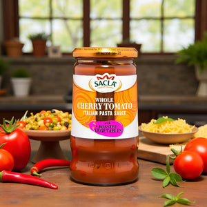 Sacla Whole Cherry Tomato Italian Pasta Sauce with roasted vegetables, fresh tomatoes, basil, and chili peppers on wooden table