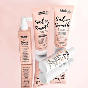 Umberto Giannini Salon Smooth hair care set with smoothing shampoo, conditioner, heat protect spray, and leave-in wonder glosser on pink background