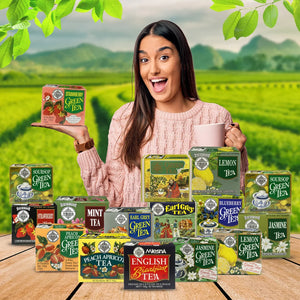Woman holding strawberry green tea box, assorted tea packages, lush tea field background