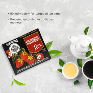 Strawberry tea box with strawberries, teapot, two tea cups, and tea leaves on a light surface