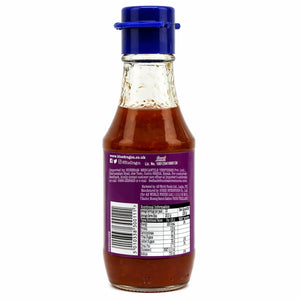 Glass bottle of sweet chilli sauce with purple label and blue cap, showing nutritional info.