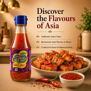 Bottle of sweet chilli sauce beside a bowl of glazed tofu garnished with red chilies and sauce