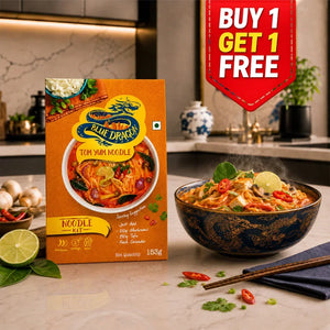 Blue Dragon Tom Yum Noodle Kit with steaming bowl, lime, and chili on kitchen counter